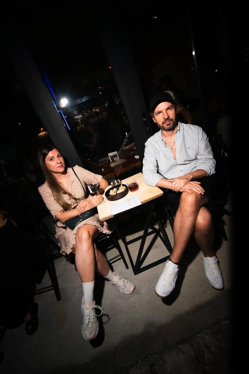 A couple relaxing at a table with snacks and drinks at LEVEL Beach Batumi